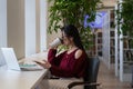 Student girl procrastinate in library with smartphone chat in social media not preparing for exam Royalty Free Stock Photo