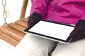 Student girl reading e-book on the bench in park. Digital tablet computer with blank isolated screen. Education background. Royalty Free Stock Photo