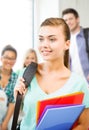 Student girl with school bag and color folders