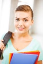 Student girl with school bag and color folders