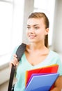 Student girl with school bag and color folders