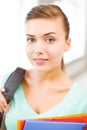 Student girl with school bag and color folders Royalty Free Stock Photo