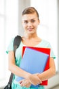 Student girl with school bag and notebooks Royalty Free Stock Photo