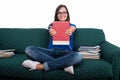 Student girl sitting on couch showing notebook Royalty Free Stock Photo