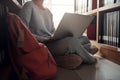 Student girl sitting on floor and using laptop, Writes notes for paper, Essay, Study for class assignment. Diverse group of Royalty Free Stock Photo