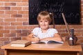 Student girl sitting at a school desk and studying math. The child is doing homework. Preschool education, self education Royalty Free Stock Photo