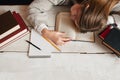 Student girl sleeping on desk with books flat lay Royalty Free Stock Photo