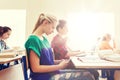 Student girl with smartphone texting at school Royalty Free Stock Photo