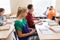 Student girl with smartphone texting at school Royalty Free Stock Photo