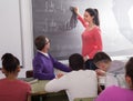 student girl solves task near blackboard in classroom mathematics Royalty Free Stock Photo