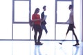 Student girl standing with laptop, people group passing by Royalty Free Stock Photo