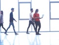 Student girl standing with laptop, people group passing by Royalty Free Stock Photo