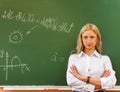 Student girl standing near blackboard in the classroom Royalty Free Stock Photo