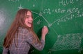 Student girl standing near clean blackboard in the classroom Royalty Free Stock Photo