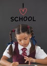 Student girl at table thinking against grey background with I love school text Royalty Free Stock Photo