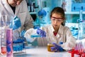 Student girl testing chemical experiment in elementary school laboratory research chemistry classroom Royalty Free Stock Photo