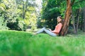 Student girl working with a laptop in a green park Royalty Free Stock Photo