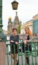 Student girls are on Italian bridge across the Griboyedov Canal Royalty Free Stock Photo