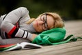 Student in glasses fell asleep on wooden stage Royalty Free Stock Photo