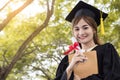 Student graduate holding certificated in hand