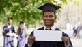 Student in graduation clothes putting up table hire me job opportunity for youth