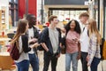 Student Group Socializing In Communal Area Of Busy College