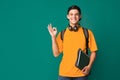 Student guy showing ok sign over turquoise background Royalty Free Stock Photo