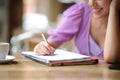 Student hand taking notes in a bar Royalty Free Stock Photo