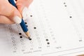 Student hand testing in exercise and passing exam carbon paper computer sheet with pencil in school test room, education concept Royalty Free Stock Photo