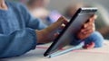 Student hand using digital tablet. Girl doing class work on tablet computer Royalty Free Stock Photo