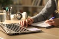 Student hands comparing notes on laptop at night Royalty Free Stock Photo