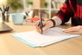 Student hands filling out application form at home Royalty Free Stock Photo