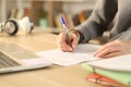Student hands filling out form document at home Royalty Free Stock Photo