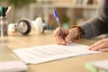 Student hands signing contract at home Royalty Free Stock Photo