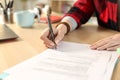 Student hands signing contract sitting at home Royalty Free Stock Photo