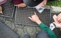 student hands sowing seeds in seed pots together