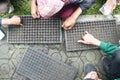 student hands sowing seeds in seed pots together