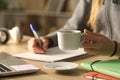 Student hands studying holding coffee cup at night Royalty Free Stock Photo