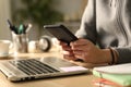 Student hands typing on smart phone at night Royalty Free Stock Photo