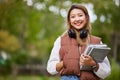 Student with headphones, portrait and woman with books for learning, education and on university campus with happiness