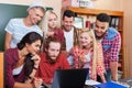 Student High School Group With Professor Using Laptop Computer Sitting At Desk, Young People Teacher Discuss