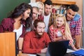 Student High School Group With Professor Using Laptop Computer Sitting At Desk, Young People Teacher Discuss Royalty Free Stock Photo