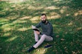 Student hipster bearded man reading a book outdoors Royalty Free Stock Photo