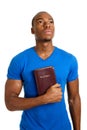 Student holding a bible looking up Royalty Free Stock Photo