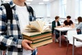 Student holding books in a library Royalty Free Stock Photo