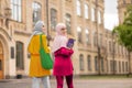 Muslim student holding books walking to classes with friend Royalty Free Stock Photo