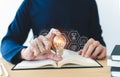 Student holding bright lightbulb and reading book or textbook. Success idea of education learning and studying. Businessperson Royalty Free Stock Photo