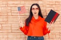 Student Holding Flag and Book Learning Foreign Language