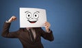 Student holding a paper with laughing emoticon in front of his face