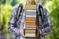 Student Holding A Stack Of Textbooks .